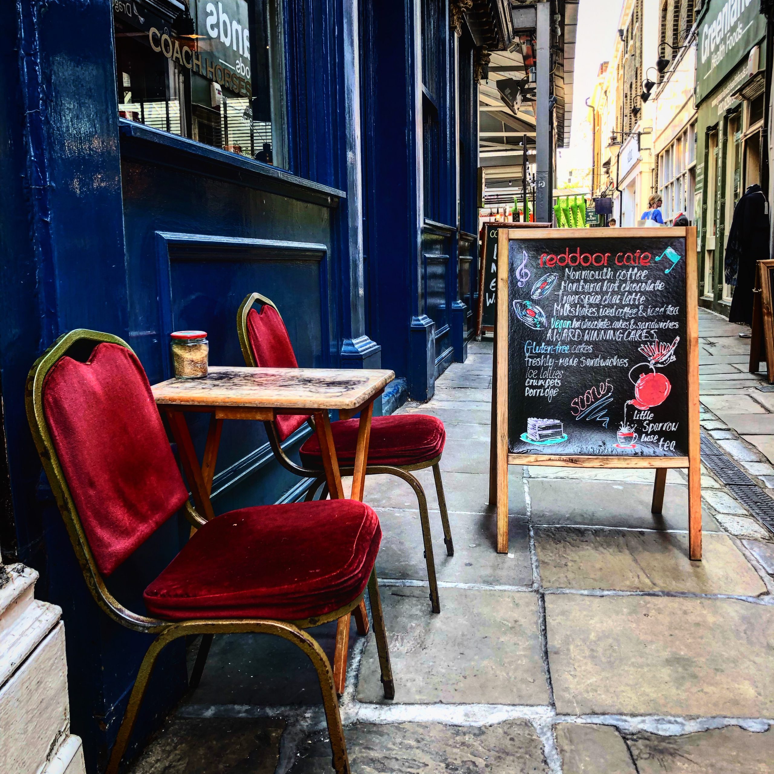 The narrow lane in front of "Reddoor Café" leads to Greenwich Market
