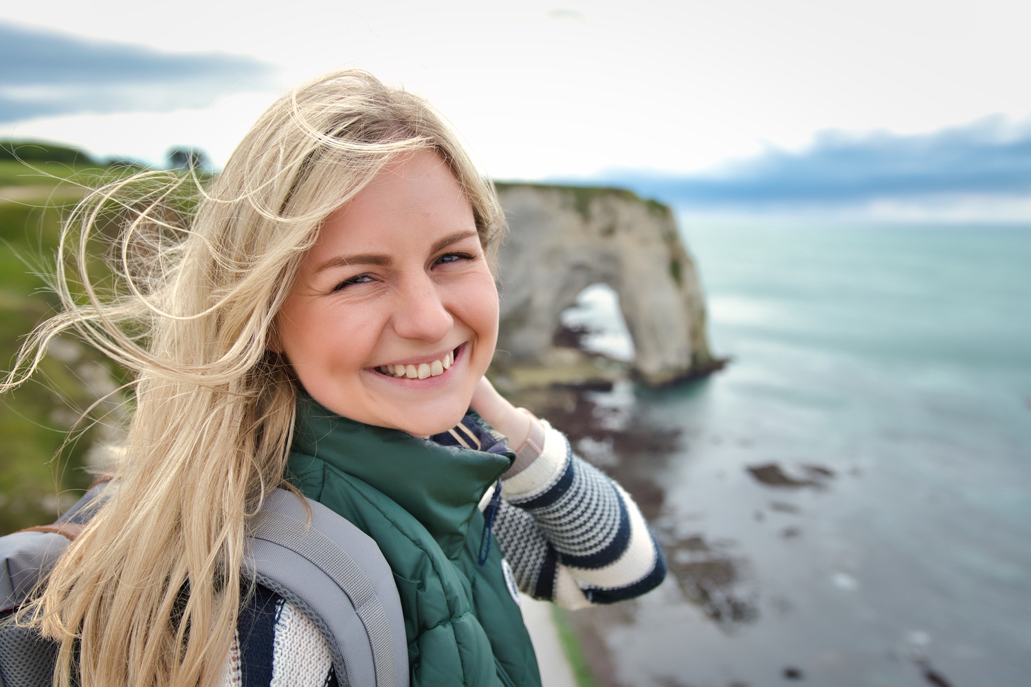 Michelle on the rocks of Étretat, in the background the famous rock arch