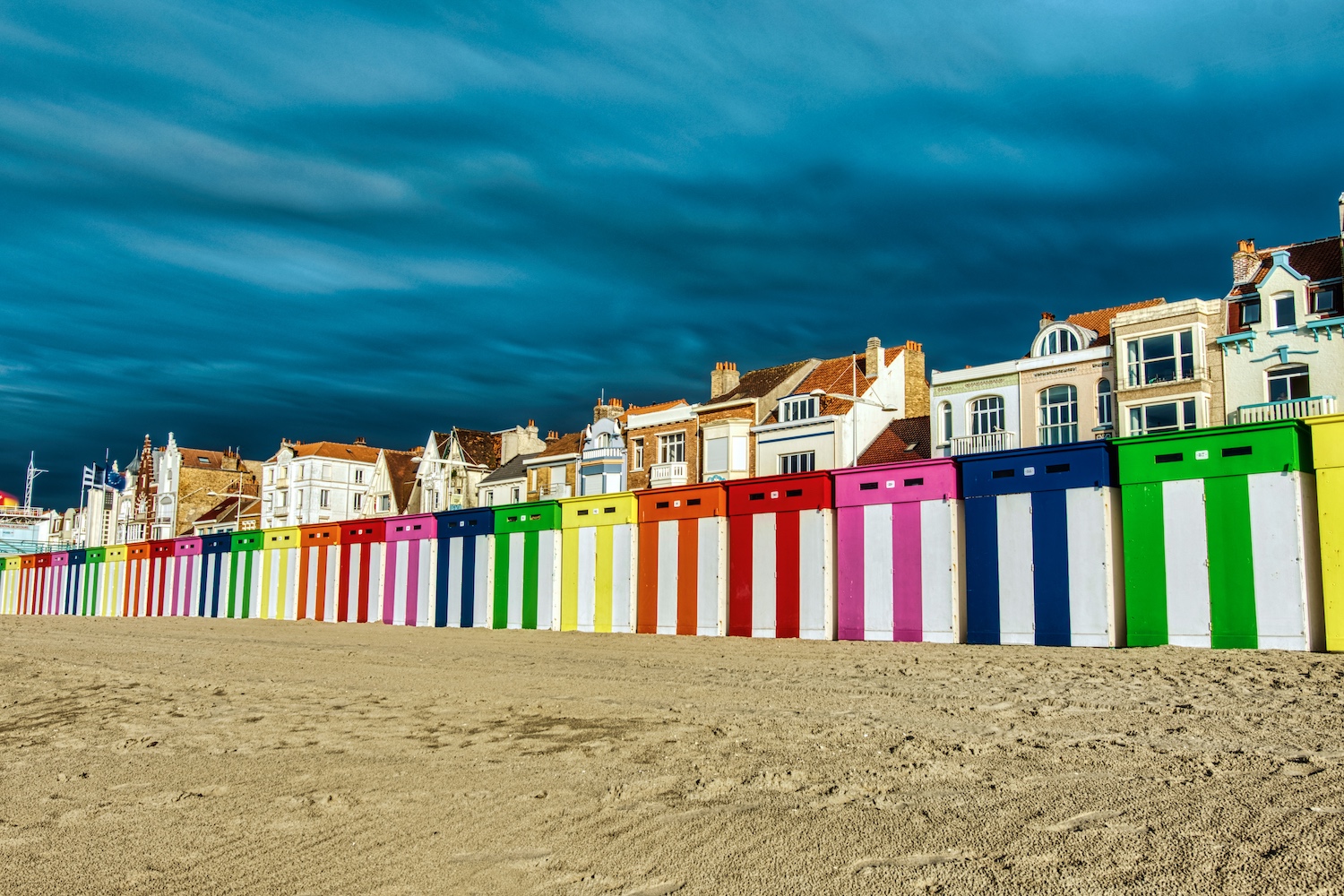 Bath cabins on the beach of Dunkerque in front of a threatening rain front