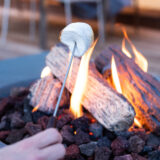Roasting marshmallows at the fire table on the terrace