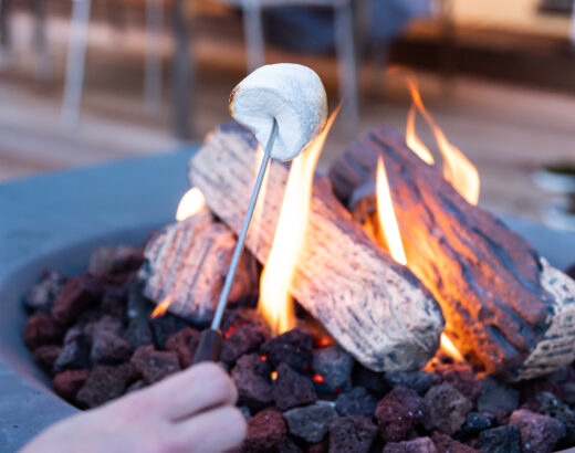 Roasting marshmallows at the fire table on the terrace
